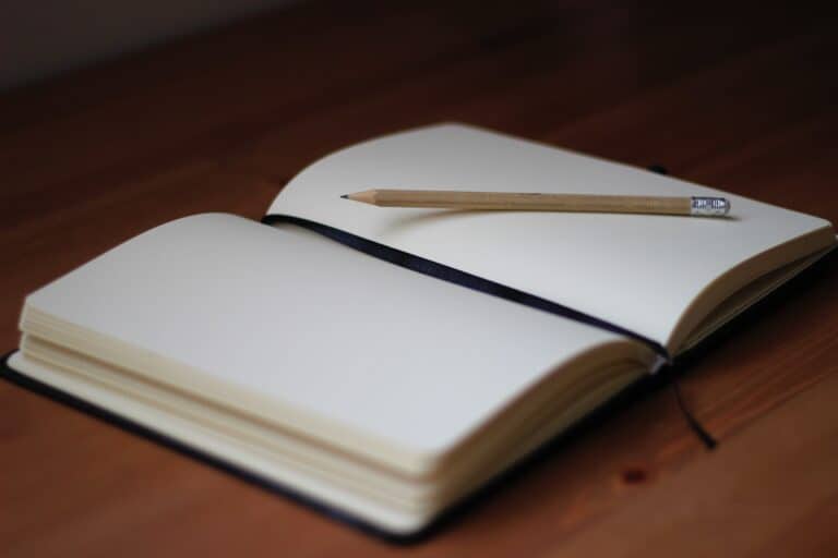 An open notebook with a pencil