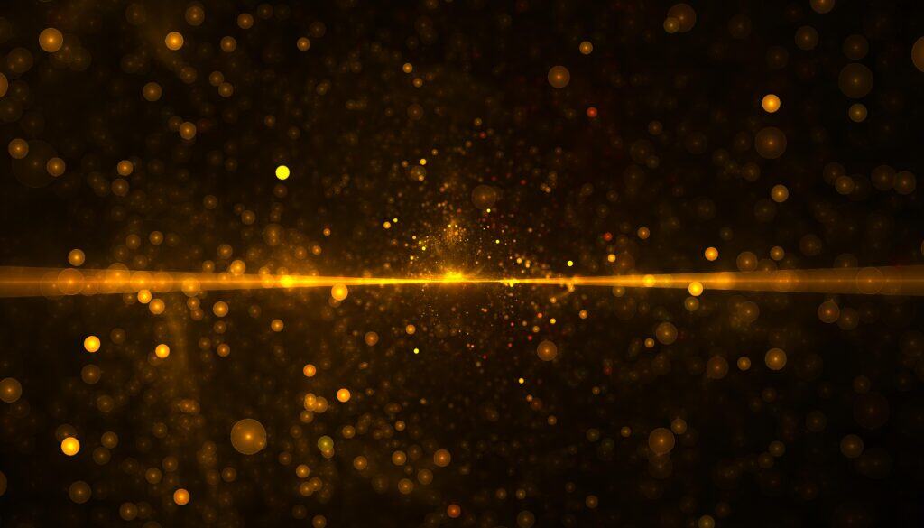 A beam of horizontal light against black with golden sparkles around it