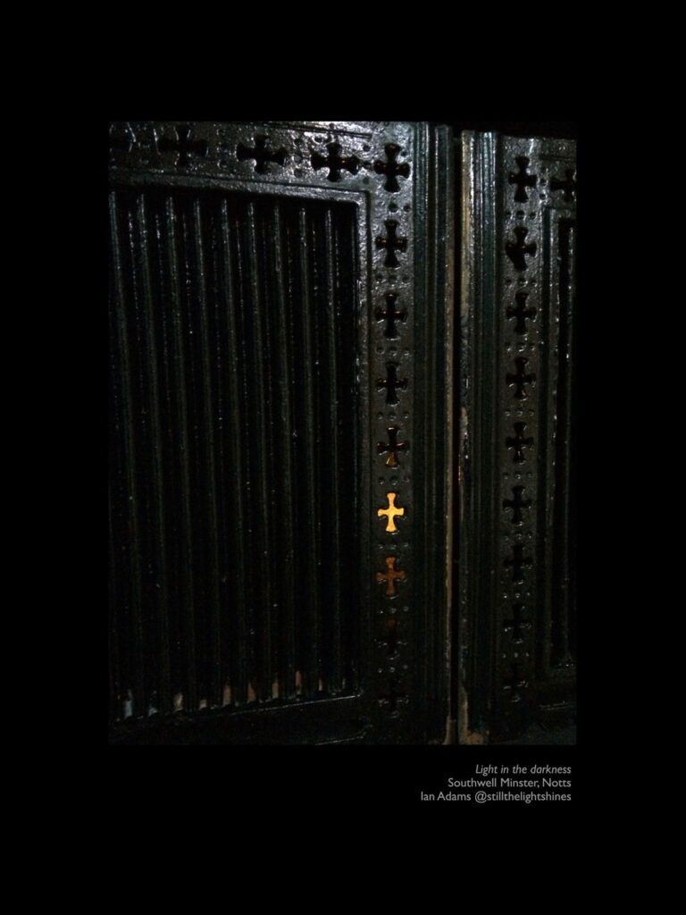 A photograph capturing the contrast of light shining through ornate ironwork in Southwells Minster, Notts.